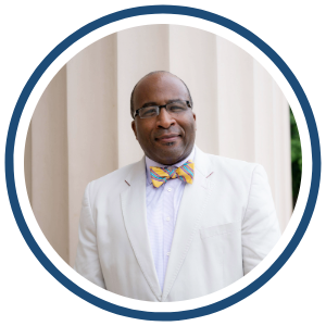 Portrait of Bill Lloyd, Director of UI REACH, wearing a light-colored suit jacket and patterned bow tie.