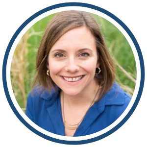 Emily Holl, Director of The Sibling Support Project Headshot of Emily Holl smiling, wearing a blue top, photographed outdoors with greenery in the background.